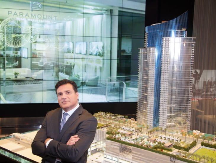 CEO Dan Kodsi in front of a model of the luxury condo building in Miami that will include skyports for flying cars. Courtesy Miami World Center News.
