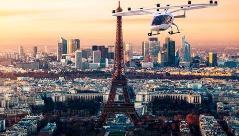 A flying car passes by the Eiffel Tower in Paris.