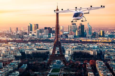 A flying car passes by the Eiffel Tower in Paris.