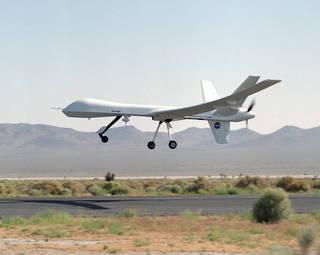 An Altair UAV prepares to land in a desert setting.