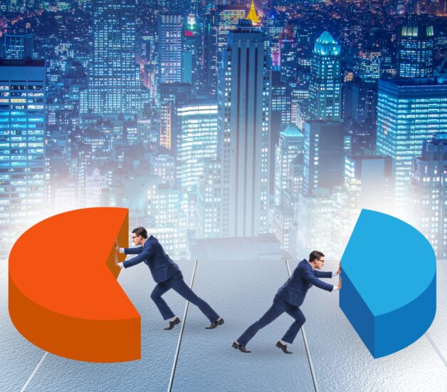 Two men in suits push aside different colors of a pie chart with an illustrated night cityscape behind them.